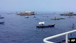 In this photo provided by the Philippine Coast Guard, fishing boats carrying a nongovernment coalition called Atin Ito, Tagalog for This is Ours, pass by waters off Palauig Point, Zambales province, northwestern Philippines as they head toward Scarborough Shoal on May 15, 2024.