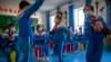 FILE - Schoolchildren dance during a music class at a primary school in Kashgar in China's Xinjiang Uyghur Autonomous Region, April 19, 2021. At the United Nations this week, 43 countries expressed in a formal statement their concerns about China's treatment of Uyghurs.