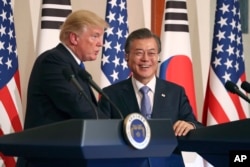 President Donald Trump, left, speaks as South Korean President Moon Jae-in looks on during a joint news conference at the Blue House in Seoul, South Korea, Tuesday, Nov. 7, 2017.