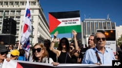 FILE - Pro-Palestinian protesters take part in a rally to express solidarity with Palestinians, in front of the parliament in Athens, Greece, on Nov. 5, 2023.