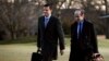 White House staff secretary Rob Porter, left, walks with White House senior adviser Stephen Miller from Marine One across the South Lawn of the White House in Washington, Feb. 5, 2018.