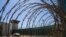FILE - In this April 17, 2019, photo, reviewed by U.S. military officials, the control tower is seen through the razor wire inside the Camp VI detention facility in Guantanamo Bay Naval Base, Cuba. 
