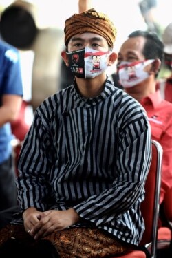 Gibran Rakabuming Raka, putra Presiden Indonesia Joko Widodo, berkumpul bersama para pendukung setelah mengumumkan kemenangan dalam pemilihan wali kota di Solo, 9 Desember 2020. (Foto: Anwar Mustafa / AFP)