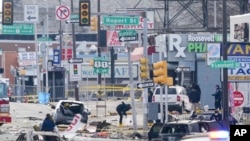 Anggota tim investigasi memeriksa lokasi kecelakaan di mana sebuah pesawat kecil jatuh di Philadelphia, pada 1 Februari 2025. (Foto: AP/Matt Rourke)