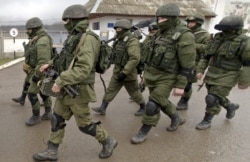 UKRAINE – Russian soldiers march outside an Ukrainian military base in Perevalne, Crimea, March 20, 2014