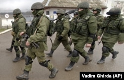 UKRAINE – Russian soldiers march outside an Ukrainian military base in Perevalne, Crimea, March 20, 2014