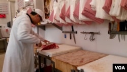 Meat is being prepared at Boucherie de l'Argonne, in Paris, Feb. 3, 2016. (L. Bryant/VOA)