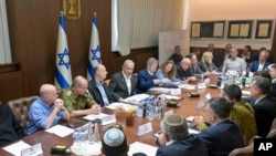 In this photo provided by the Israeli Government Press Office, Prime Minister Benjamin Netanyahu, center, meets with his security Cabinet to recommend a ceasefire deal to pause the 15-month war with Hamas in Gaza, in Jerusalem, Jan. 17, 2025.