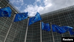 FILE PHOTO: European Union flags flutter outside the European Commission headquarters in Brussels