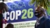 FILE - People stand by the Africa pavilion at the previous COP26 U.N. Climate Change Conference in Glasgow on Nov. 2, 2021.