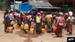 FILE - This photo taken on April 29, 2024, shows Kayah people gathering at a delivery of drinking water by the charity Clean Yangon at a camp for internally displaced people in Demoso township, in Myanmar's eastern Kayah state.