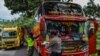 Para petugas memeriksa sebuah bus penumpang pada hari pertama penerapan larangan mudik nasional untuk mencegah penyebaran pandemi COVID-19, di Tasikmalaya, Jawa Barat, 6 Mei 2021. (Foto: Adeng Bustomi/ Antara Foto via Reuters)