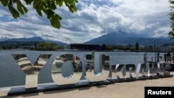 A sign is displayed in front of the Burgenstock Resort ahead of the Ukraine Peace Summit near Lucerne, Switzerland, June 14, 2024.