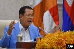 FILE - Cambodia's Prime Minister Hun Sen speaks to the media during a press conference at the Peace Palace in Phnom Penh, April 7, 2020.