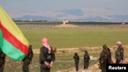 Kurdish members of the Self-Defense Forces stand near the Syrian-Turkish border in the Syrian city of al-Derbasiyah, Feb. 9, 2016. Syrian Kurds declared on March 17, 2106, a federal region in areas they control in the northern part of the country. 