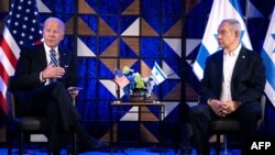 US President Joe Biden (L) speaks as Israel's Prime Minister Benjamin Netanyahu listens on prior to their meeting in Tel Aviv on October 18, 2023, amid the ongoing battles between Israel and the Palestinian group Hamas.