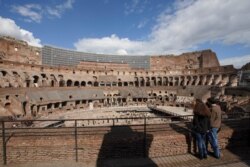 Tourists visit the Colosseum, in Rome, March 7, 2020. With the coronavirus emergency deepening in Europe, Italy, a focal point in the contagion, risks falling back into recession as foreign tourists are spooked from visiting its cultural treasures.