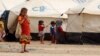 Displaced children, who fled from the Islamic State violence, gather at a refugee camp in the Makhmour area near Mosul, Iraq, June 17, 2016. 