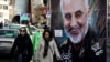 Women walk past a banner of Iranian Revolutionary Guard Gen. Qassem Soleimani, who was killed in Iraq in a U.S. drone attack Friday, in Tajrish square in northern Tehran, Iran, Jan. 9, 2020.