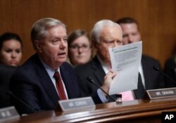 Senate Judiciary Committee member Sen. Lindsey Graham, R-S.C., left, accompanied by fellow committee member Sen. Orrin Hatch, R-Utah, questions FBI Director nominee Christopher Wray, July 12, 2017, on Capitol Hill in Washington.