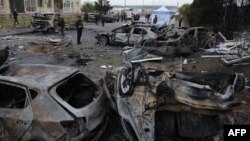 Local residents inspect burnt-out cars in the courtyard of a residential building following a drone attack in Odesa, Ukraine, on Nov. 9, 2024.