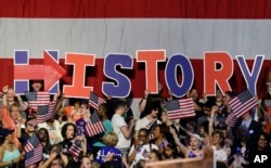 Supporters of presumptive Democratic presidential candidate Hillary Clinton hold up letters to spell out the significance of the day's voting results during a rally in New York, June 7, 2016. (AP)