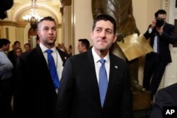 FILE - House Speaker Paul Ryan of Wisconsin, center, leaves the House Chamber after voting on the Republican tax bill, Dec. 19, 2017, on Capitol Hill in Washington.