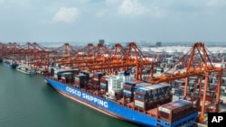 FILE - In this photo released by Xinhua News Agency, aerial photo shows a container ship berthed at the container wharf of Qinzhou Port in Qinzhou in southern China's Guangxi Zhuang Autonomous Region on Sept. 13, 2022. (Zhang Ailin/Xinhua via AP)