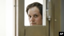 Wall Street Journal reporter Evan Gershkovich stands in a glass cage in a courtroom at the Moscow City Court in Moscow, Russia June 22, 2023