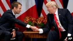 FILE - President Donald Trump shakes hands with French President Emmanuel Macron during a meeting at the Palace Hotel, Sept. 18, 2017, in New York.