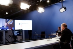 German Chancellor Olaf Scholz listens to opening remarks from U.S. President Joe Biden at the start of the virtual Summit for Democracy, at the Chancellery in Berlin on December 9, 2021. (Michele Tantussi/Reuters)