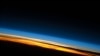 FILE - This image of sunset on the Indian Ocean was taken by astronauts aboard the International Space Station (ISS). The image presents an edge-on, or limb view, of the Earth’s atmosphere as seen from orbit.