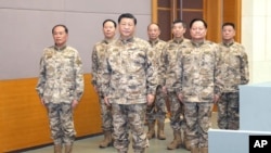 FILE - In this photo released by Xinhua News Agency, Chinese President Xi Jinping, front center, inspects the Central Military Commission joint operations command center on Nov. 8, 2022. 