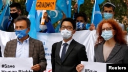 Aktivis prodemokrasi Hong Kong Nathan Law (tengah) bersama dengan sejumlah aktivis lainnya menggelar aksi protes di tengah kedatangan Menteri Luar Negeri China Wang Yi ke Berlin, Jerman, pada 1 September 2020. (Foto: Reuters/Michele Tantussi)