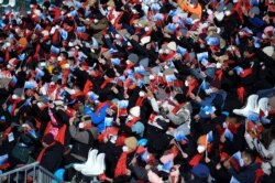Spectators wave flags during the FIS Ski Cross World Cup 2022, part of a 2022 Beijing Winter Olympic Games test event at Genting Snow Park in Chongli county, Zhangjiakou city, China's Hebei province, Nov. 27, 2021.