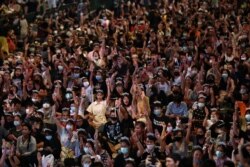 Pro-democracy protesters flash the three-finger salute during a 'Bad Student' rally in Bangkok, Thailand, Nov. 21, 2020.