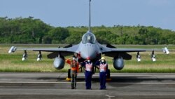 台湾空军人员在一架完成升级的F-16V战机交付仪式上敬礼。（2021年11月18日）