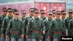 Members of Chinese People's Liberation Army (PLA) Air Force Red Falcon aerobatic team attend the China International Aviation and Aerospace Exhibition in Guangdong province, China, Sept. 28, 2021. 
