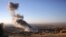 FILE - Smoke believed to be from an airstrike billows over the northern Iraqi town of Sinjar, Nov. 12, 2015. A man on an IS-released video denounced such strikes by "infidels."