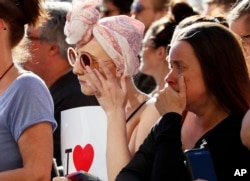 People attend a vigil in Albert Square, Manchester, England, May 23, 2017, the day after the suicide attack at an Ariana Grande concert that left 22 people dead as it ended on Monday night.