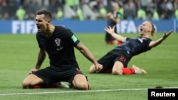 
Pesepak bola Kroasia, Dejan Lovren dan Domagoj Vida merayakan kemenangan atas Inggris dalam laga semifinal Piala Dunia 2018 di Stadion Luzhniki, Moskow, Rusia, 11 Juli 2018.
