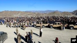 People attend the funeral prayer of Khalil Haqqani, the minister for refugees and repatriation, during his funeral procession in eastern Paktia province, Afghanistan, Dec. 12, 2024.