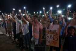 Mourners in Ciudad Juarez, Mexico, take part in a vigil near the border fence between Mexico and the U.S after a mass shooting at a Walmart store in El Paso, Texas, Aug. 3, 2019.