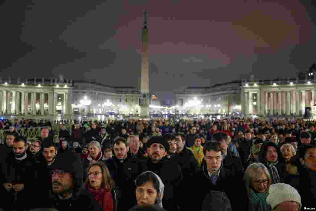 Faithful attend a prayer service in St. Peter's Square, as the Pope continues treatment at Gemelli Hospital, at the Vatican, Feb. 24, 2025. 