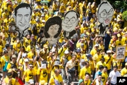 Activists from the Coalition for Clean and Fair Elections (Bersih), march during a rally in Kuala Lumpur, Malaysia, Nov. 19, 2016. Thousands of yellow-shirt protesters rallied Saturday, seeking Prime Minister Najib Razak's resignation over a financial scandal.