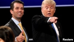FILE - Donald Trump Jr. (L) gives a thumbs up beside his father Republican U.S. presidential nominee Donald Trump (R) after Trump's debate against Democratic nominee Hillary Clinton at Hofstra University in Hempstead, New York, Sept, 26, 2016. 