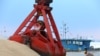 FILE - Imported soybeans are transported at a port in Nantong, Jiangsu province, China, Aug. 6, 2018. 