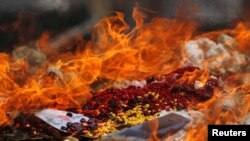FILE - Confiscated drugs burned during a ceremony to mark the International Day against Drug Abuse and Illicit Trafficking, in Phnom Penh, Cambodia, June 26, 2018. REUTERS/Samrang Pring