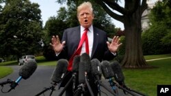 President Donald Trump speaks to the media on the South Lawn of the White House in Washington, May 23, 2018, en route to a day trip to New York. 