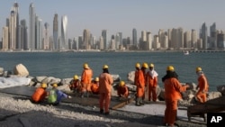 FILE - Laborers work at a construction site at the Palm Jumeirah in Dubai, United Arab Emirates, Sept. 22, 2015.